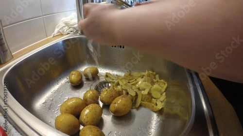 Potato cleaning in the sink photo