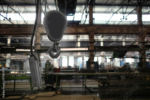 Hook of crane in factory workshop
