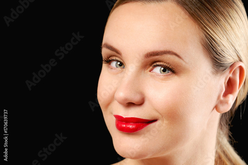 Young woman with straight hair on dark background