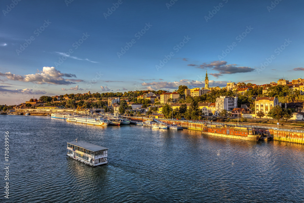 Boat on Sava and sunset over Belgrade. HDR image