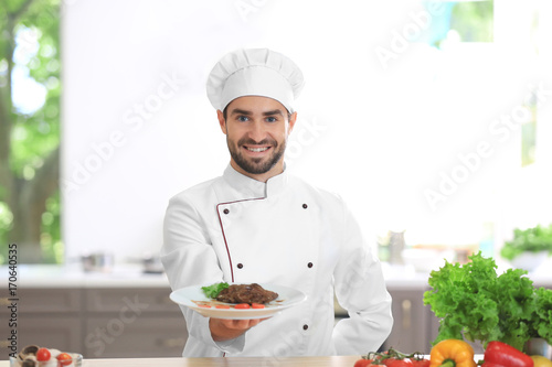 Young male chef holding fre...