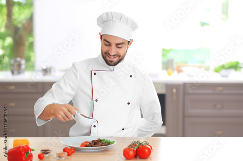 Young male chef pouring sau...