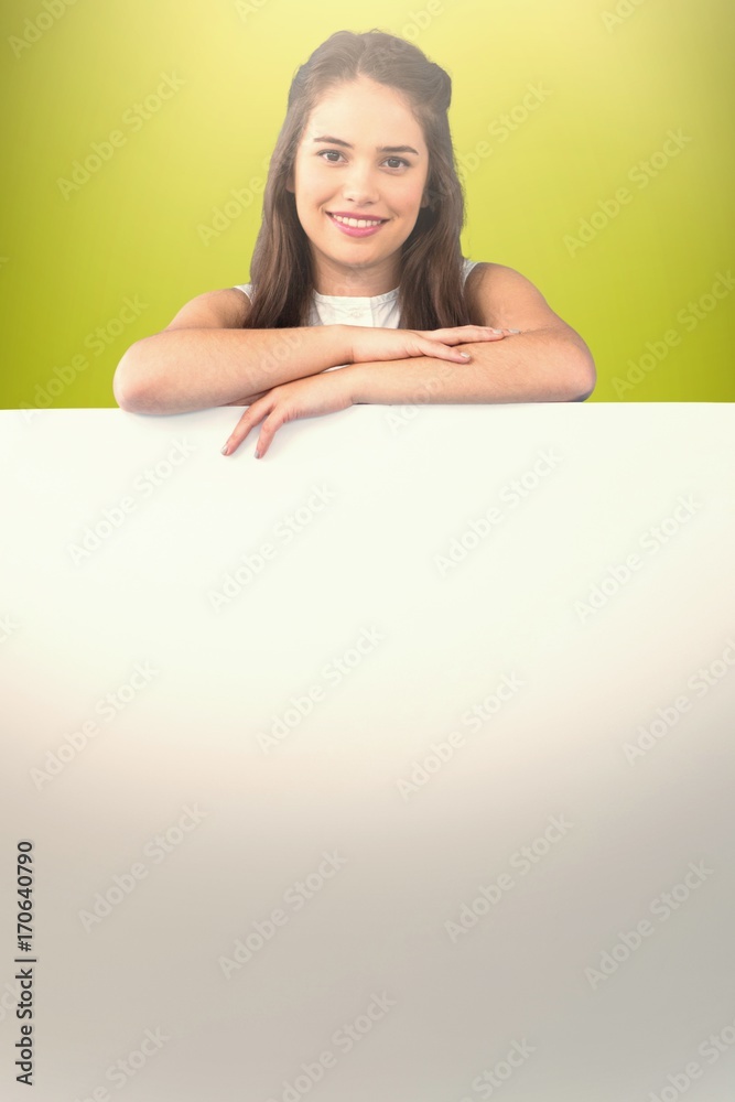 Composite image of beautiful brunette women holding blank poster Composite image of beautiful brunette women holding blank poster