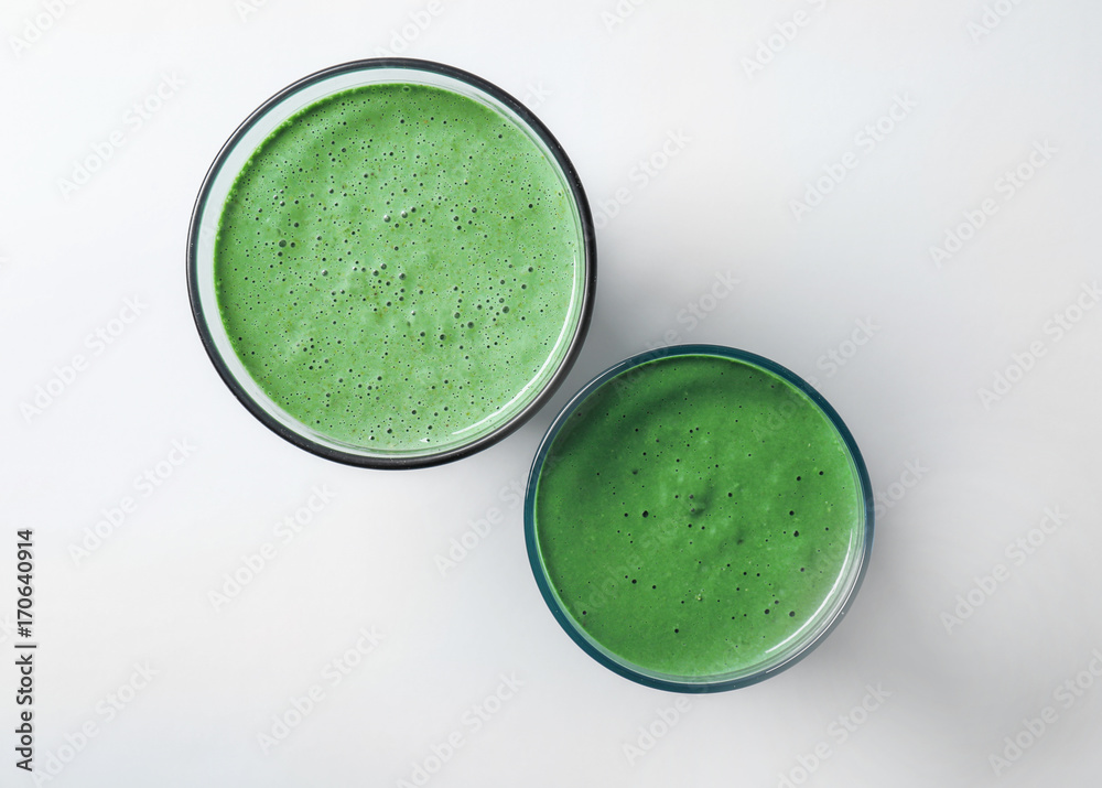 Glasses of fresh green smoothie on white background Glasses of fresh green smoothie on white background