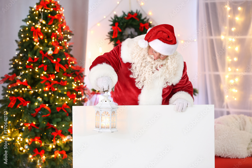 Fototapeta premium Authentic Santa Claus with poster in room decorated for Christmas