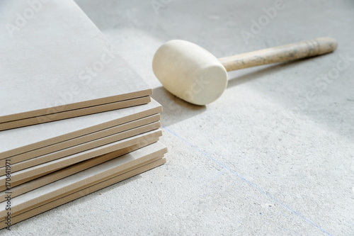 Ceramic tile and rubber hammer.