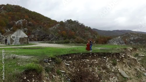 Man plays the cello on the mountains, outdoors. Footage. Musician with a happy look on his face having a break while performing a cello in a field landscape photo