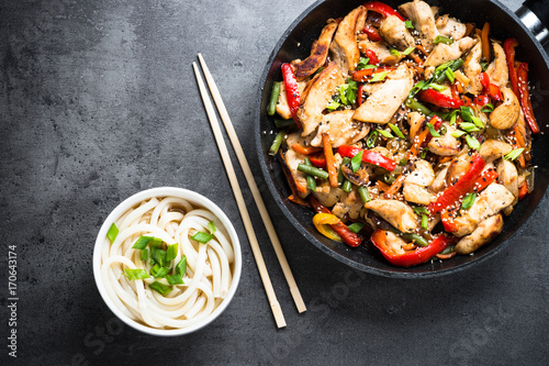 Chicken Stir fry and udon noodles on black.