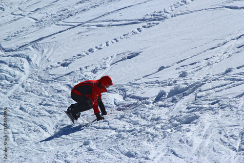 Skiers and snowboarders riding on a ski slope in Sochi mountain resort snowy winter photo