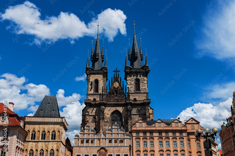 Old Town of Prague, Czech Republic. View on Tyn Church and Jan Hus Memorial on the square as seen from Old Town City Hall. Blue sunny sky