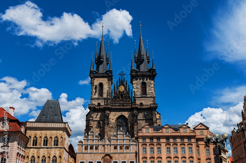 Old Town of Prague, Czech Republic. View on Tyn Church and Jan Hus Memorial on the square as seen from Old Town City Hall. Blue sunny sky