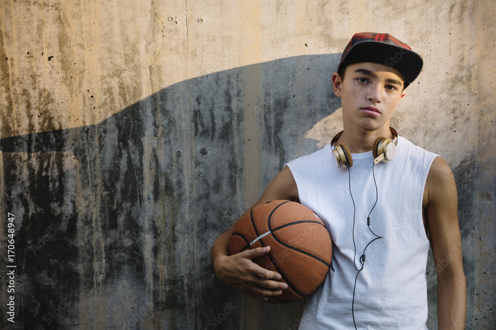 Naklejka premium Young Man Holding a Basketball Ball