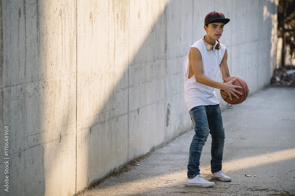 Young Man Holding a Basketball Ball