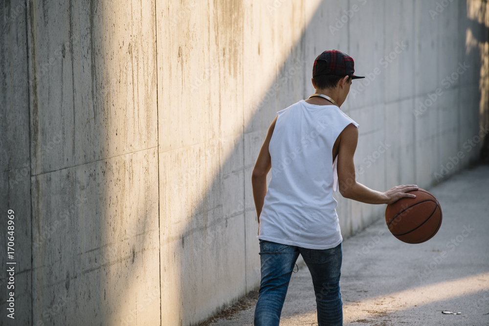 Fototapeta premium Young Man Holding a Basketball Ball