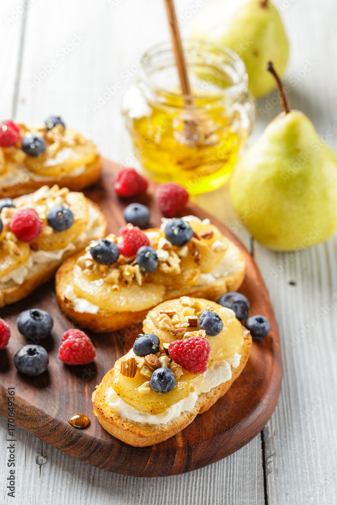 Toasts with pear, cream cheese, nuts and honey. Toasts with pear, cream cheese, nuts and honey.