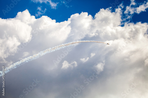 Unrecognizable airplane on airshow. Aerobatic fighter performs flight in the blue sky © prescott09