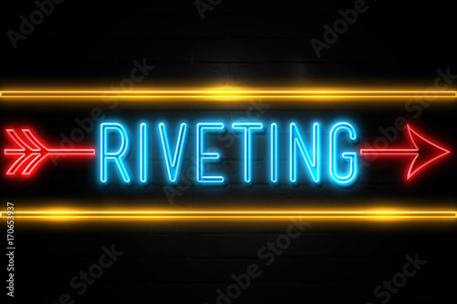Riveting  - fluorescent Neon Sign on brickwall Front view