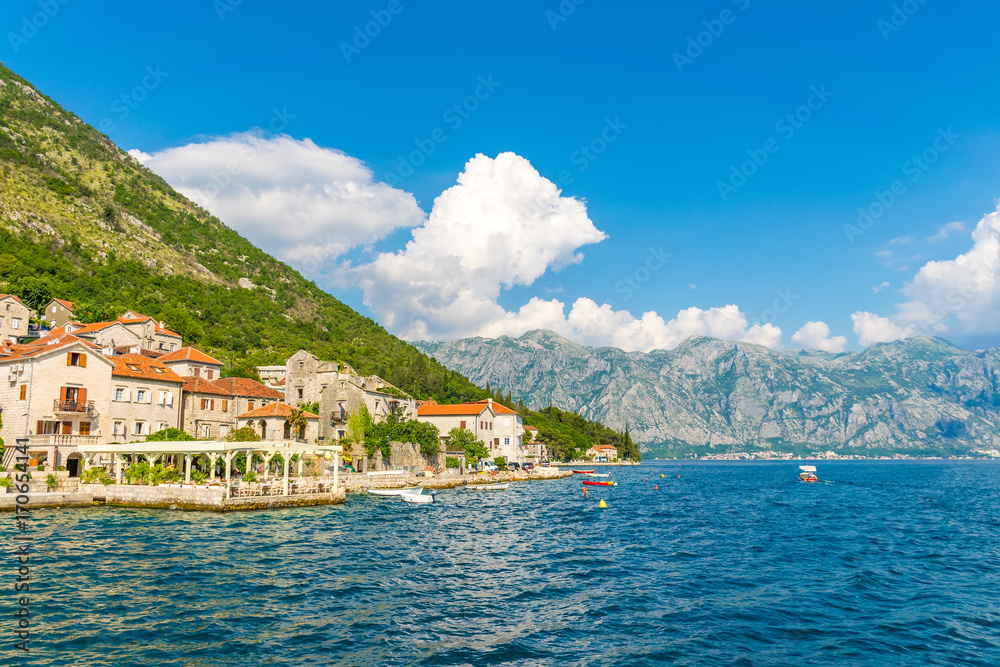 MONTENEGRO - JUNE 04/2017. Tourists sailed on the yacht past the city of Perast in the Boka Bay of Kotor.