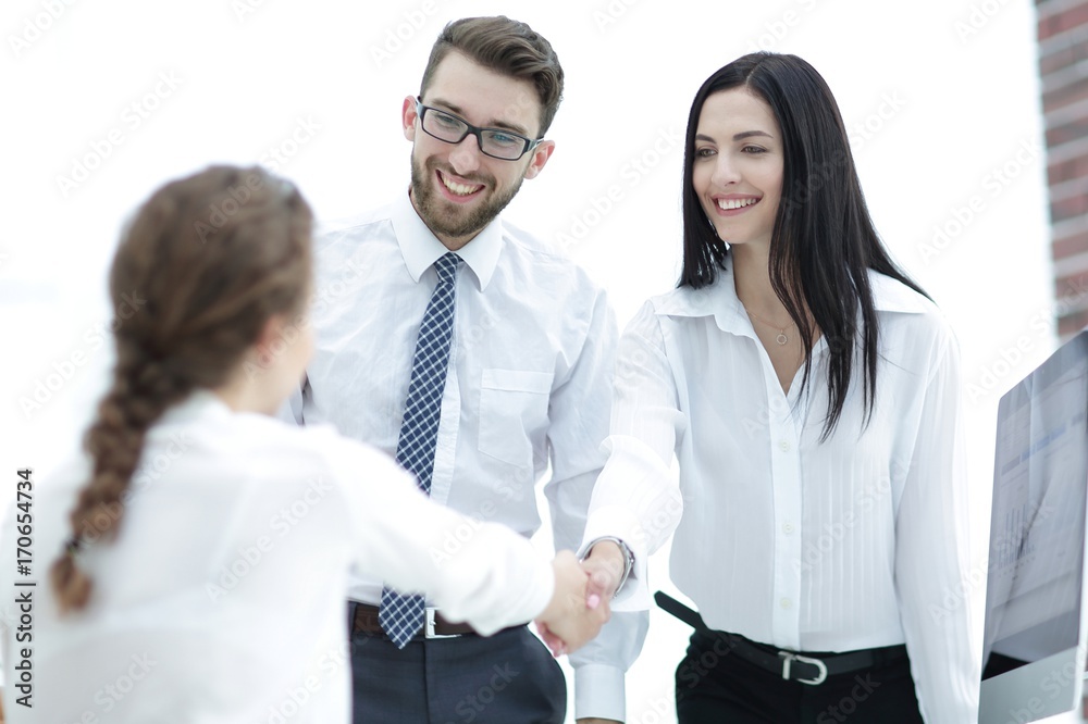 young business woman shaking hands with a colleague young business woman shaking hands with a colleague