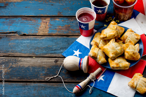 Chilean independence day concept. fiestas patrias. Chilean typical dish and drink on independence day party, 18 september. Mini empanadas, mote con huesillo, wine with toasted flour, chicha and photo