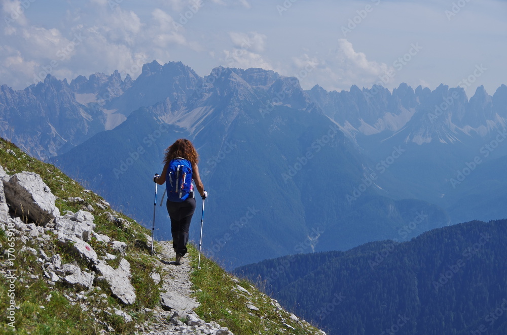 Young woman hiking in the Dolomites