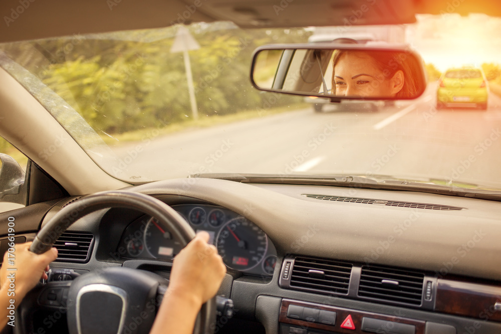 Fototapeta premium Beautiful woman driving a car on the road
