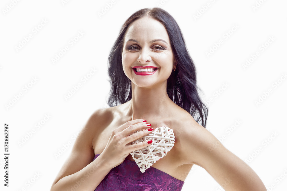 Smiling Caucasian Woman with White Wicker Heart Holding. In Front of Herself with One Hand. Smiling Caucasian Woman with White Wicker Heart Holding. In Front of Herself with One Hand.