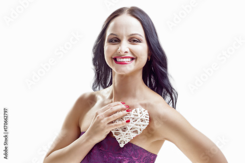 Smiling Caucasian Woman with White Wicker Heart Holding. In Front of Herself with One Hand.