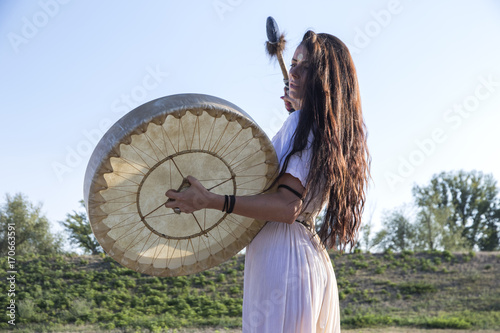 Shaman woman  drumming profile