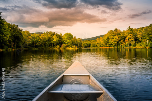 Aluminum canoe on a mountain lake upstate New York. Camping. outdoors and adventure concept. Faded, vintage color post processed