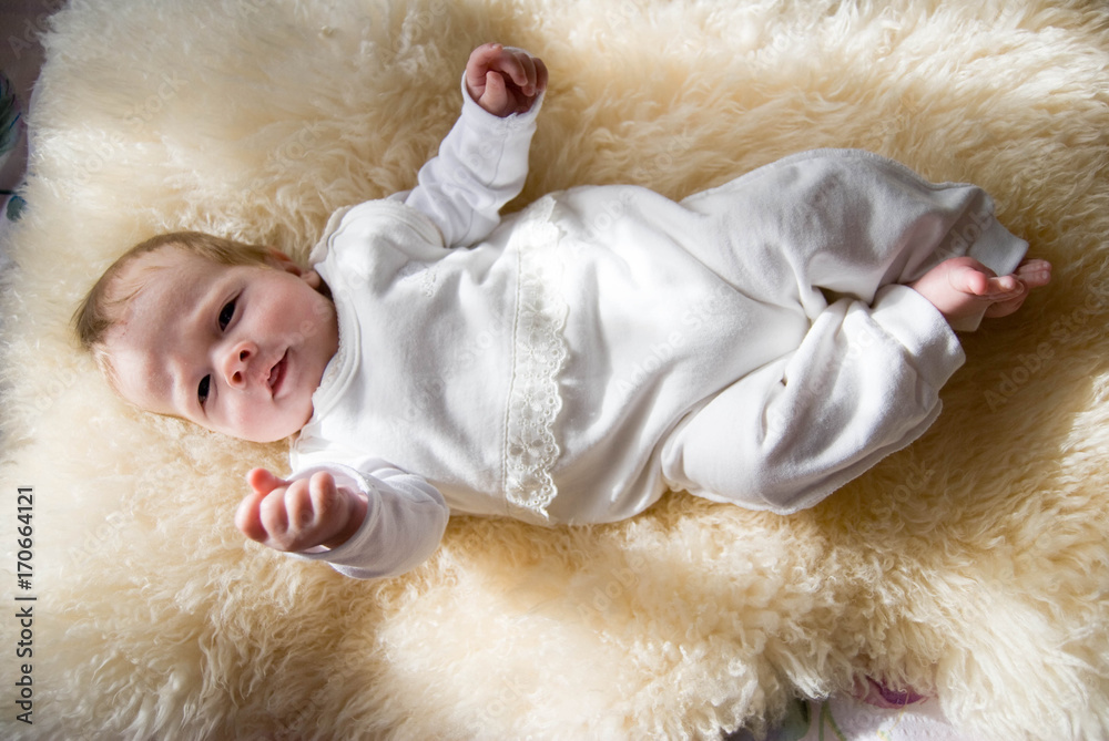 newborn happy sweet baby on furry blanket in soft colors