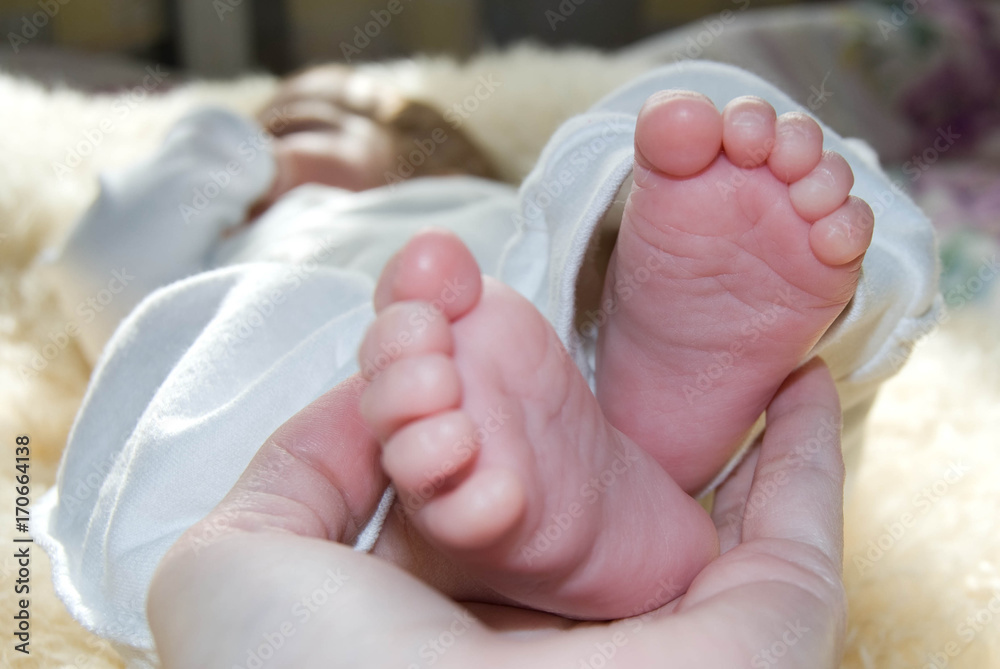 Legs (foot) of an infant with small baby fingers