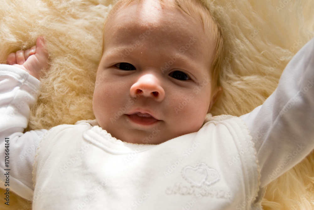 newborn happy sweet baby on furry blanket in soft colors