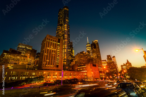 Brooklyn Bridge, Downtown Manhattan, New York. Night scene. Light trails. City lights. Urban living and transportation concept