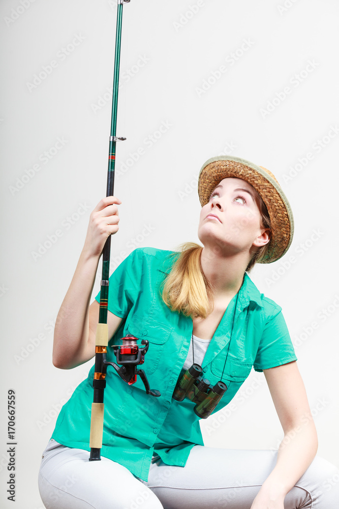 Bored woman with fishing rod, spinning equipment Bored woman with fishing rod, spinning equipment