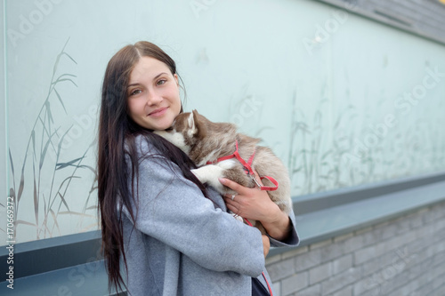 portrait of a young women with a husky puppies