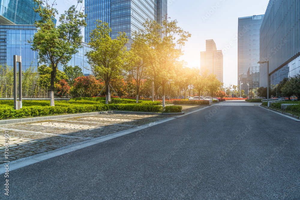 empty asphalt road near glass office building