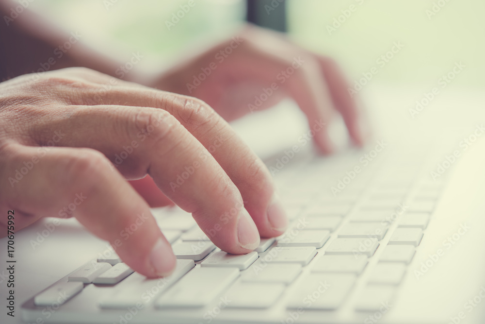 close up of man hands working on laptop. On the table close up of man hands working on laptop. On the table