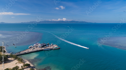 Aerial view of Koh Phangan international port with boats in the clear blue sea