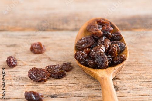 Raisins on a wood background.