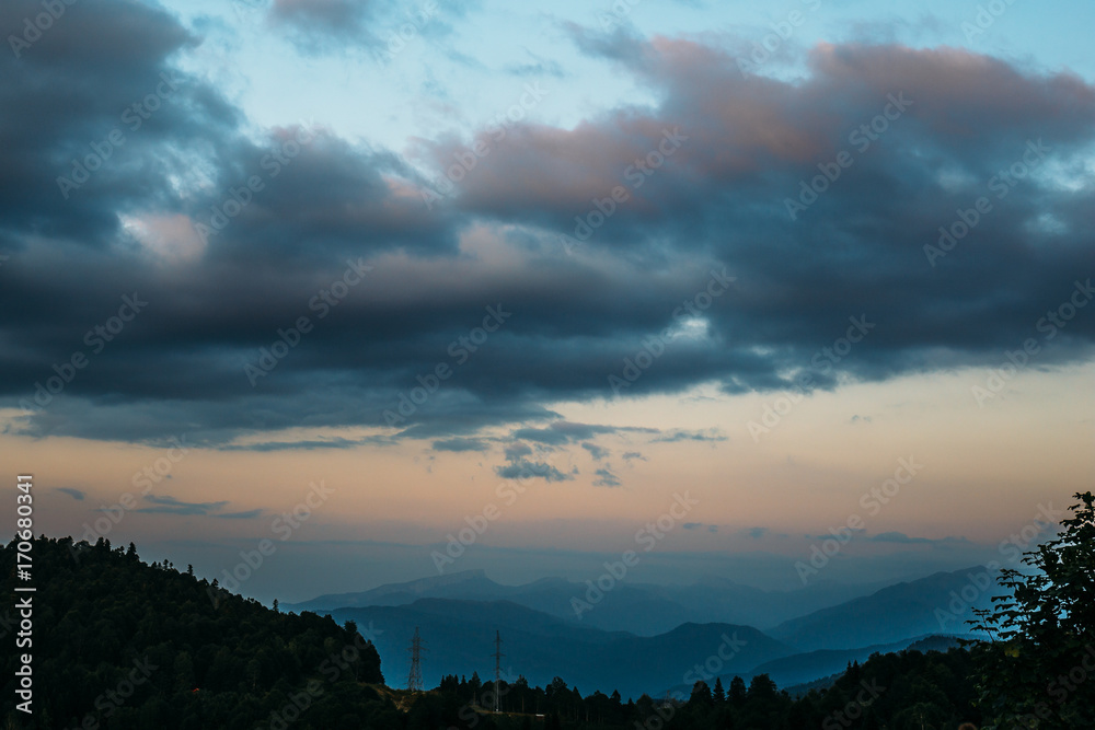 Mountain landscape, layers of mountains in fog and big clouds Mountain landscape, layers of mountains in fog and big clouds