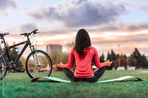 Girl beautiful brunette. Athletic body , pumped muscles. Bright colors , green ,pink .running in the Park . photo