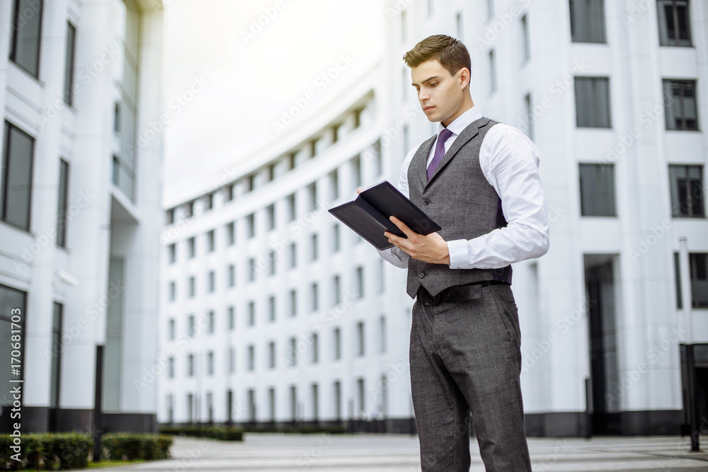 Handsome businessman in suit standing on the street. Handsome businessman in suit standing on the street.