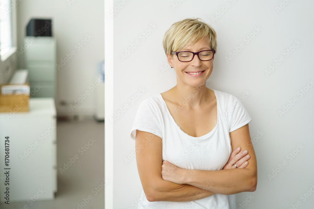 lächelnde frau steht im büro und schließt die augen lächelnde frau steht im büro und schließt die augen
