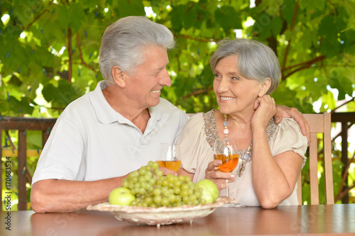 elderly couple drinking wine