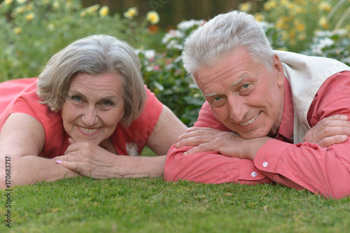senior couple lying on meadow