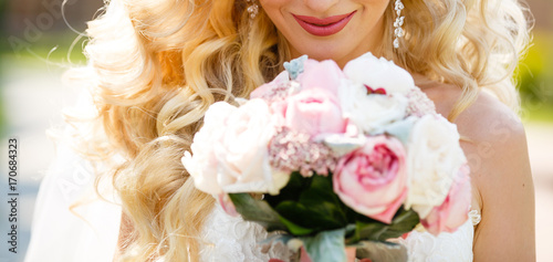 Wedding bouquet in bride's hands, Rich bunch of peach and cream peony and roses flower, Selective focus.