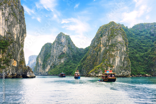 Tourist junks floating  between limestone karsts and isles in Ha long Bay, Vietnam