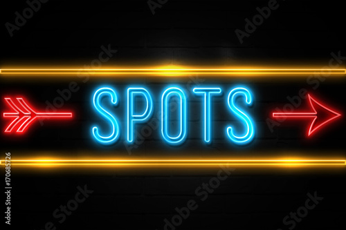 Spots - fluorescent Neon Sign on brickwall Front view