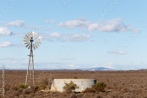 Windmill with a dam in the field